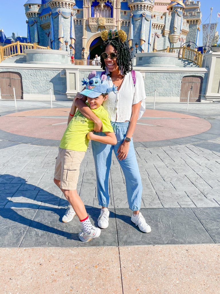 Disney World Photo Idea - Laughing in front of Cinderella's Castle on Main Street | ordinarilyextraordinarymom #disneyworldphotos #disneyphotos #disneyphotospots #disneyphotoideas #disneyphotoideaskids
